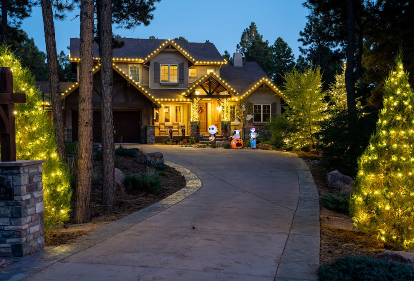 Large home with warm Seasonal Christmas Lighting